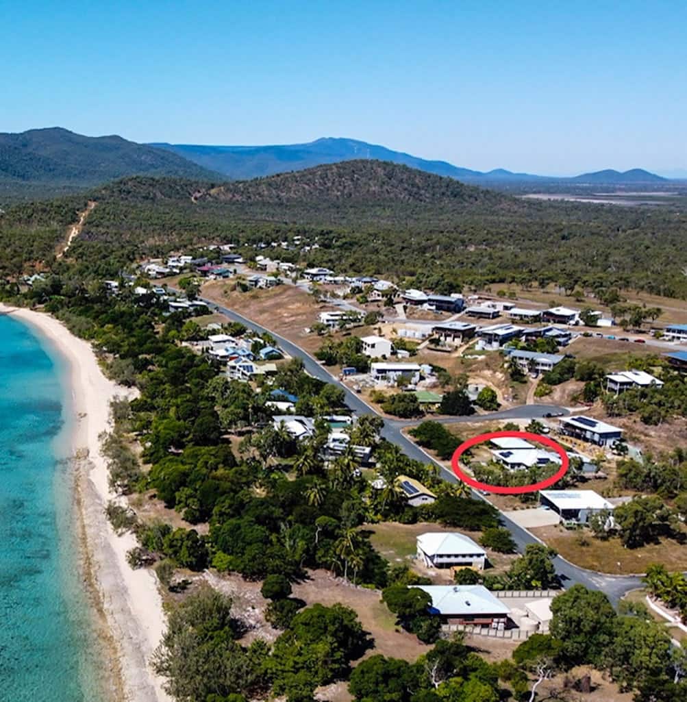 Pristine turquoise waters and white sand at Hideaway Bay Beach in the Whitsundays.