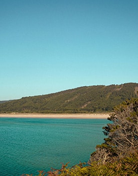 Scenic view of the quiet, sandy coastline and turquoise waters at Cape Gloucester in the Whitsundays.