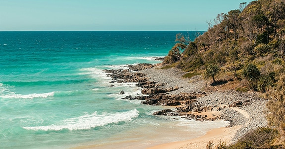 Scenic coastal view of the turquoise ocean and rocky headlands near Dingo Beach and Cape Gloucester.